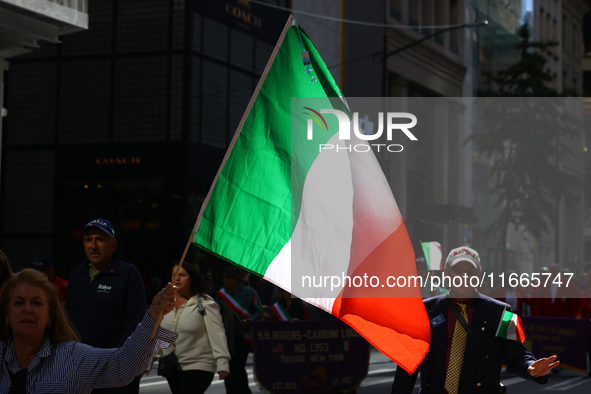 Participants wave flags as they march up 5th Avenue in the Columbus Day Parade in New York City, United States, on October 14, 2024. 