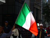 Participants wave flags as they march up 5th Avenue in the Columbus Day Parade in New York City, United States, on October 14, 2024. (