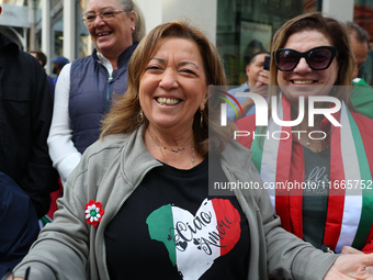 Spectators wave flags and show off Italian heritage as they march up 5th Avenue in the Columbus Day Parade in New York City, United States,...