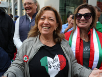 Spectators wave flags and show off Italian heritage as they march up 5th Avenue in the Columbus Day Parade in New York City, United States,...