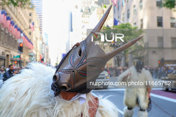 Performers in costume pose for a photo during the Columbus Day Parade in New York City, United States, on October 14, 2024. 