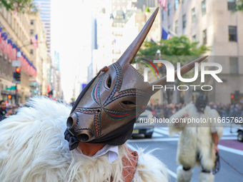 Performers in costume pose for a photo during the Columbus Day Parade in New York City, United States, on October 14, 2024. (