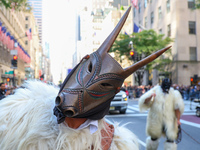 Performers in costume pose for a photo during the Columbus Day Parade in New York City, United States, on October 14, 2024. (