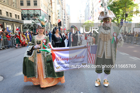 Performers in costume pose for a photo during the Columbus Day Parade in New York City, United States, on October 14, 2024. 