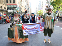 Performers in costume pose for a photo during the Columbus Day Parade in New York City, United States, on October 14, 2024. (