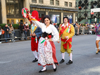 Performers in costume pose for a photo during the Columbus Day Parade in New York City, United States, on October 14, 2024. (