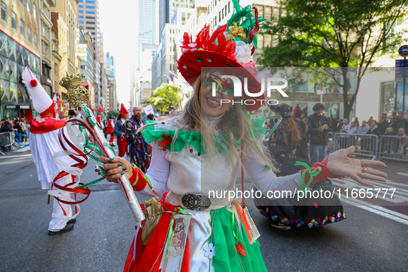 Performers in costume pose for a photo during the Columbus Day Parade in New York City, United States, on October 14, 2024. 