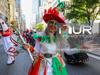 Performers in costume pose for a photo during the Columbus Day Parade in New York City, United States, on October 14, 2024. (