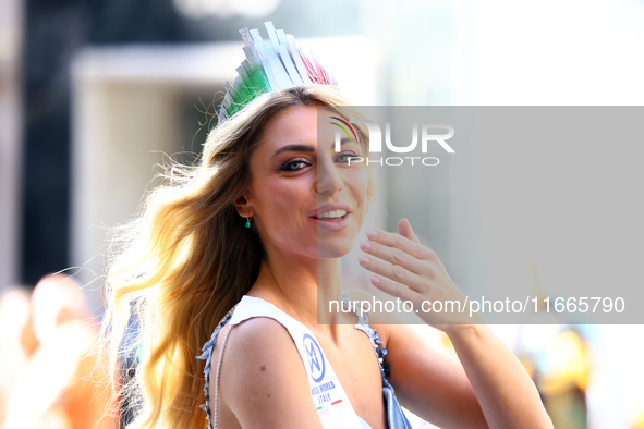 Miss World Italy Lucrezia Mangilli waves to crowds while heading up 5th Avenue in the Columbus Day Parade in New York City, United States, o...