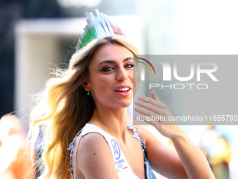 Miss World Italy Lucrezia Mangilli waves to crowds while heading up 5th Avenue in the Columbus Day Parade in New York City, United States, o...