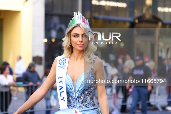 Miss World Italy Lucrezia Mangilli waves to crowds while heading up 5th Avenue in the Columbus Day Parade in New York City, United States, o...