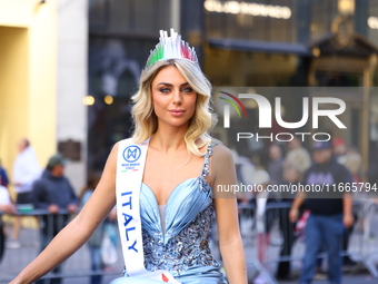 Miss World Italy Lucrezia Mangilli waves to crowds while heading up 5th Avenue in the Columbus Day Parade in New York City, United States, o...