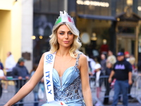 Miss World Italy Lucrezia Mangilli waves to crowds while heading up 5th Avenue in the Columbus Day Parade in New York City, United States, o...