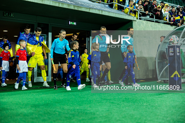 Referees officiate a match of the UEFA Nations League between the Ukraine and Czechia national teams in Wroclaw, Poland, on October 14, 2024...