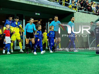 Referees officiate a match of the UEFA Nations League between the Ukraine and Czechia national teams in Wroclaw, Poland, on October 14, 2024...