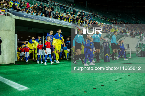 Referees officiate a match of the UEFA Nations League between the Ukraine and Czechia national teams in Wroclaw, Poland, on October 14, 2024...