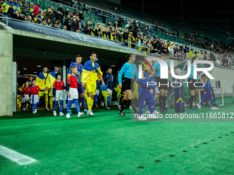 Referees officiate a match of the UEFA Nations League between the Ukraine and Czechia national teams in Wroclaw, Poland, on October 14, 2024...