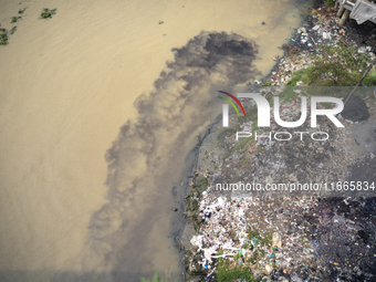 Water appears pitch black as industrial waste falls into the Shitalakkhya River in Dhaka, Bangladesh, on October 14, 2024. (