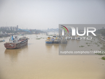 Cargo ships anchor in the Shitalakkhya River in Dhaka, Bangladesh, on October 14, 2024. (