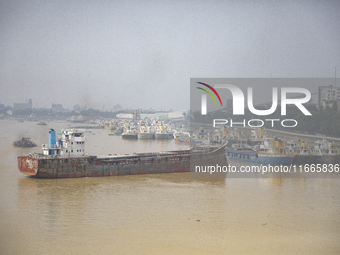 Cargo ships anchor in the Shitalakkhya River in Dhaka, Bangladesh, on October 14, 2024. (