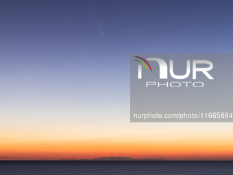 The comet Tsuchinshan-ATLAS (C/2023 A3) is seen over the mountains of the Calabria region from the viewpoint of Torre Uluzzo, near Lecce, It...