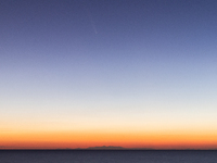 The comet Tsuchinshan-ATLAS (C/2023 A3) is seen over the mountains of the Calabria region from the viewpoint of Torre Uluzzo, near Lecce, It...