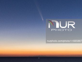 The comet Tsuchinshan-ATLAS (C/2023 A3) is seen over the mountains of the Calabria region from the viewpoint of Torre Uluzzo, near Lecce, It...