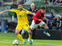 Oleksandr Svatok, Adam Hlozek are playing during the  UEFA Nations League 2024 League B Group B1 match between Ukraine and Czechia , at the...