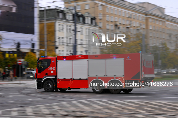 A truck belonging to the special chemical and ecological rescue group is seen speeding through the city center in Warsaw, Poland on 14 Octob...