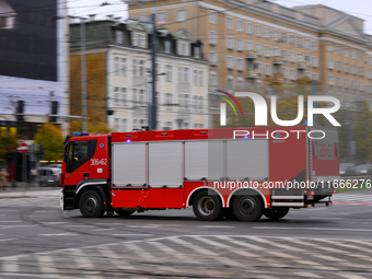 A truck belonging to the special chemical and ecological rescue group is seen speeding through the city center in Warsaw, Poland on 14 Octob...