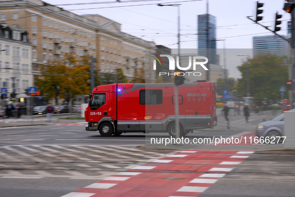 A truck belonging to the special chemical and ecological rescue group is seen speeding through the city center in Warsaw, Poland on 14 Octob...