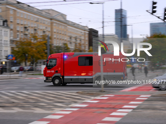 A truck belonging to the special chemical and ecological rescue group is seen speeding through the city center in Warsaw, Poland on 14 Octob...