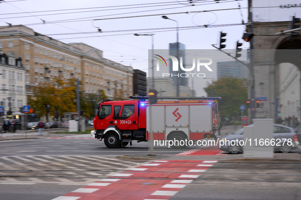 A truck belonging to the special chemical and ecological rescue group is seen speeding through the city center in Warsaw, Poland on 14 Octob...