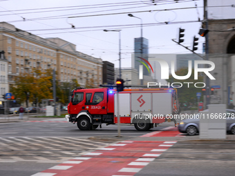 A truck belonging to the special chemical and ecological rescue group is seen speeding through the city center in Warsaw, Poland on 14 Octob...