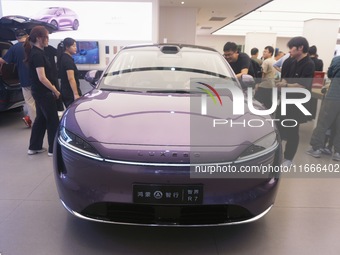 A customer watches a Huawei HIMA (Harmony Intelligent Mobility Alliance) LUXEED R7 in a Huawei store in Hangzhou, Zhejiang Province, China,...