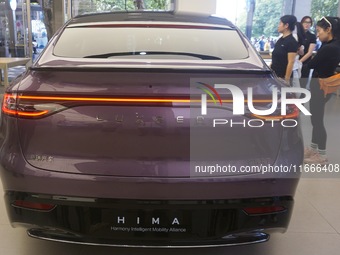 A customer watches a Huawei HIMA (Harmony Intelligent Mobility Alliance) LUXEED R7 in a Huawei store in Hangzhou, Zhejiang Province, China,...