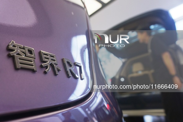 A customer watches a Huawei HIMA (Harmony Intelligent Mobility Alliance) LUXEED R7 in a Huawei store in Hangzhou, Zhejiang Province, China,...