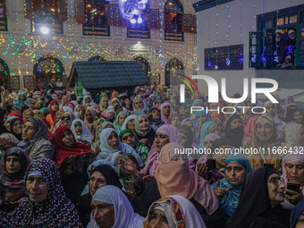 Kashmiri Muslim women pray upon seeing a relic of Sheikh Abdul Qadir Jeelani, a Sufi saint, on his death anniversary outside his shrine in S...