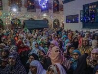 Kashmiri Muslim women pray upon seeing a relic of Sheikh Abdul Qadir Jeelani, a Sufi saint, on his death anniversary outside his shrine in S...