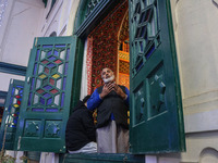 A Kashmiri Muslim man prays upon seeing a relic of Sheikh Abdul Qadir Jeelani, a Sufi saint, on his death anniversary outside his shrine in...