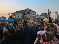 Kashmiri Muslims raise their arms in prayer upon seeing a relic of Sheikh Abdul Qadir Jeelani, a Sufi saint, on his death anniversary outsid...