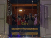 Kashmiri Muslim women raise their arms in prayer upon seeing a relic of Sheikh Abdul Qadir Jeelani, a Sufi saint, on his death anniversary o...