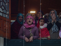 A Kashmiri Muslim woman reacts upon seeing a relic of Sheikh Abdul Qadir Jeelani, a Sufi saint, on his death anniversary outside his shrine...