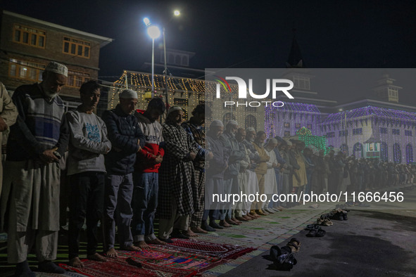 Kashmiri Muslims offer prayers at the shrine of Sheikh Abdul Qadir Jeelani, a Sufi saint, on his death anniversary outside his shrine in Sri...