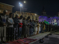 Kashmiri Muslims offer prayers at the shrine of Sheikh Abdul Qadir Jeelani, a Sufi saint, on his death anniversary outside his shrine in Sri...