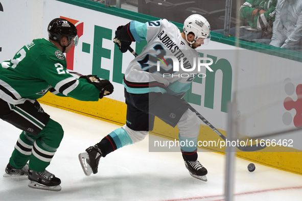 Oliver Bjorkstrand #22 of the Seattle Kraken skates on the ice while controlling the puck during the NHL match between the Dallas Stars and...