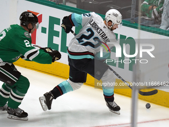 Oliver Bjorkstrand #22 of the Seattle Kraken skates on the ice while controlling the puck during the NHL match between the Dallas Stars and...