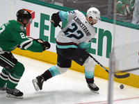 Oliver Bjorkstrand #22 of the Seattle Kraken skates on the ice while controlling the puck during the NHL match between the Dallas Stars and...