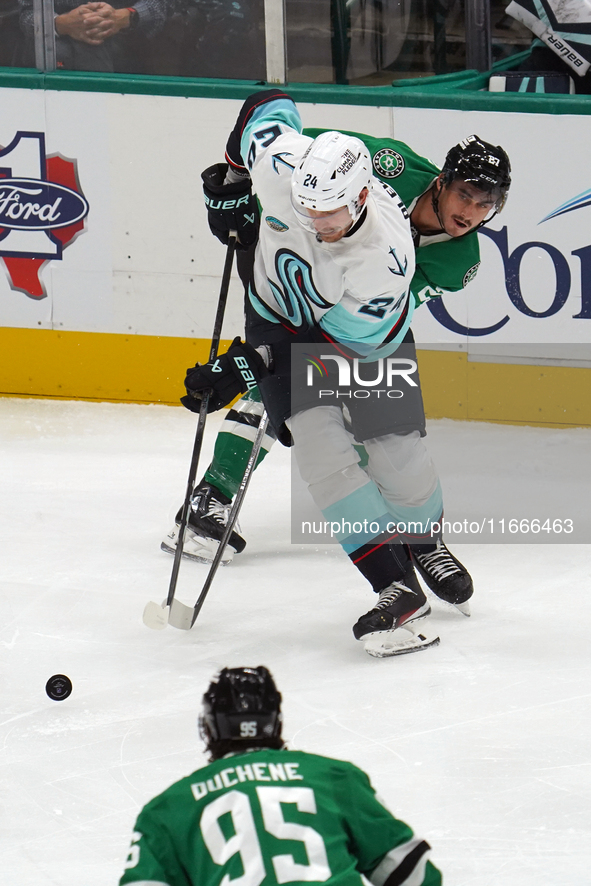 Mason Marchment #27 of the Dallas Stars and Jamie Oleksiak #24 of the Seattle Kraken skate on the ice while battling for the puck during the...