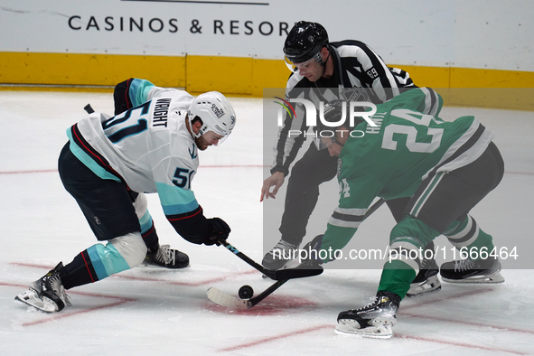 Roope Hintz #24 of the Dallas Stars and Shane Wright #51 of the Seattle Kraken line up against one another during the NHL match between the...